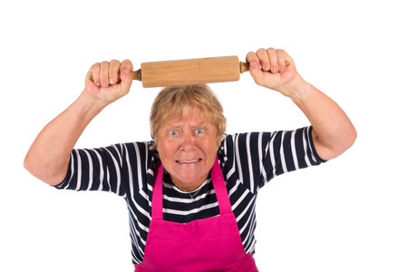 Very angry elder woman with pin roller isolated over white backgroundの写真素材