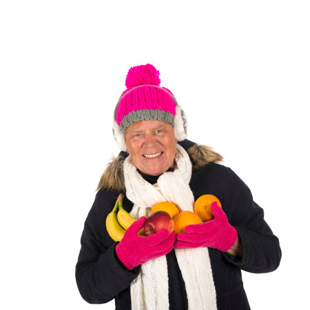 Healthy winter woman with fruit isolated over white backgroundの写真素材