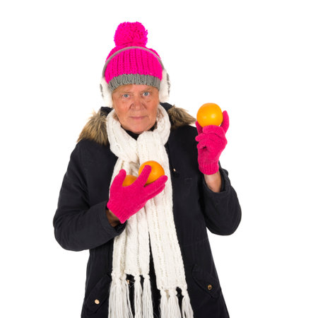 Healthy winter woman with fruit isolated over white backgroundの写真素材