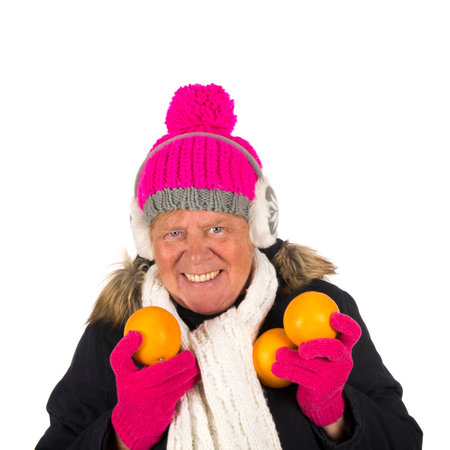 Healthy winter woman with fruit isolated over white backgroundの写真素材