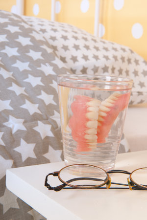 Bedroom old peoples home with false teeth and glassesの写真素材