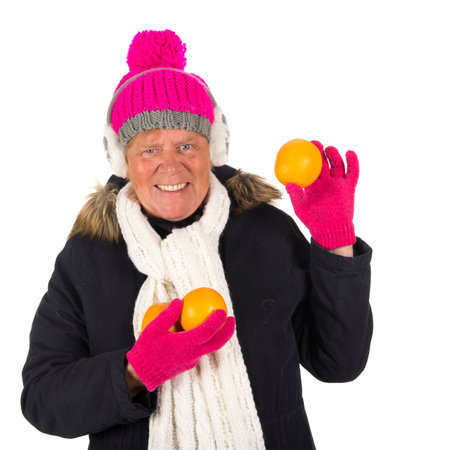 Healthy winter woman with fruit isolated over white backgroundの写真素材