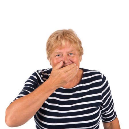 Portrait blonde senior woman laughing on white backgroundの写真素材