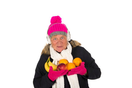 Healthy winter woman with fruit isolated over white backgroundの写真素材