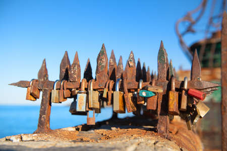 Many old rusty love lockers at the beachの写真素材