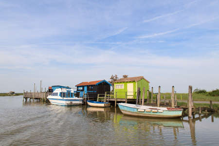 French wooden oyster huts at boat dock in landscape in the France Charente Maritimeの写真素材