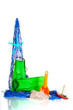 Fishing net with toys and star fish at the beachの写真素材