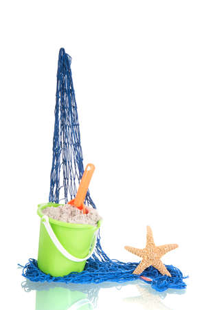 Blue fishing net with plastic toys isolated over whiteの写真素材