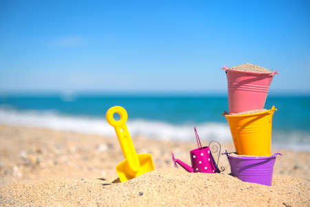 Colorful toy buckets at the beachの写真素材