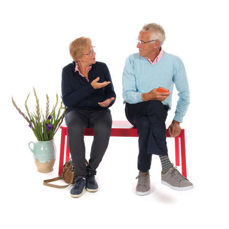 Senior couple sitting in waiting roomの写真素材