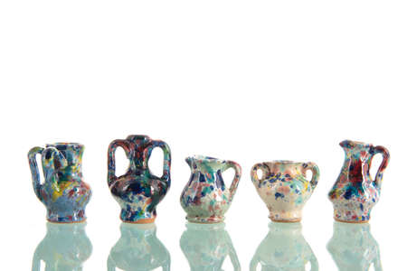Pottery vases in many colors isolated over white backgroundの写真素材