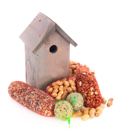 Bird nest box and winter food isolated over white backgroundの写真素材
