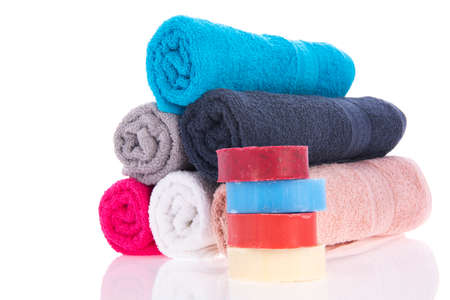 Pink towels with soap isolated over white backgroundの写真素材
