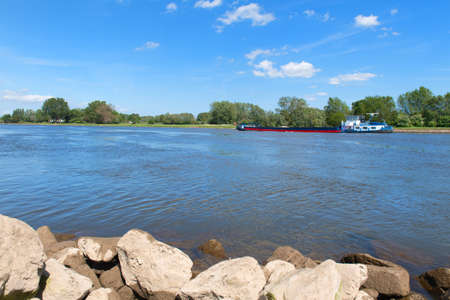 Landscape Dutch river the IJssel with boat