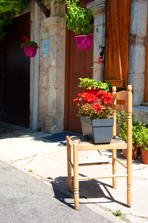 Romantic chair with Geraniums in the sunshineの写真素材