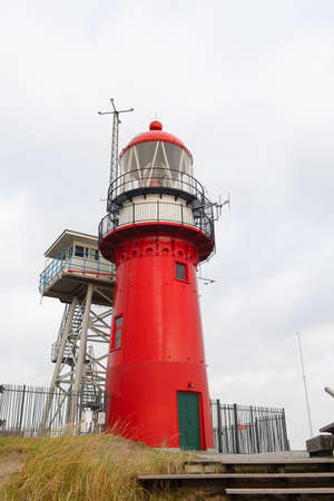 Red lighthouse on Dutch wadden island Vlielandの写真素材