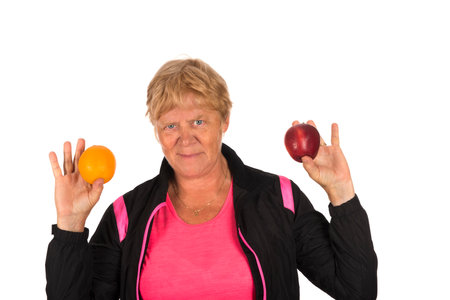 Old Fit sporty Healthy woman with fruit isolated over white backgroundの写真素材