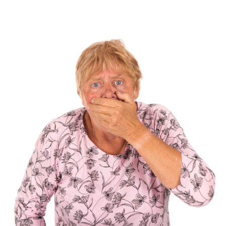 Portrait blonde senior woman with finger for attention on white backgroundの写真素材