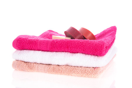 Pink towels with soap isolated over white backgroundの写真素材