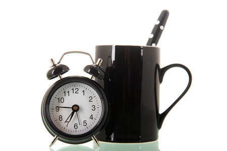 Morning coffee with mug and alarm clockの写真素材