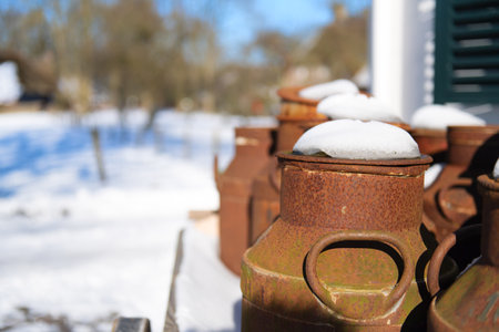 Typical Dutch rusty milk cans in snowの写真素材