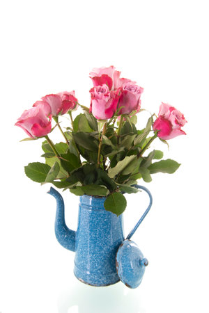 Colorful bouquet gerber flowers in blue vintage vase isolated over white backgroundの写真素材