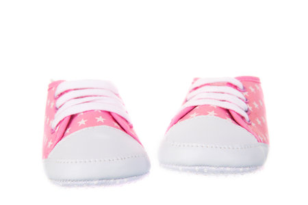 Girly baby shoes isolated over white backgroundの写真素材