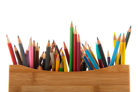 Color pencils in wooden box isolated over white backgroundの写真素材