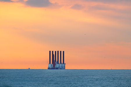 Oil rig in sunset at sea