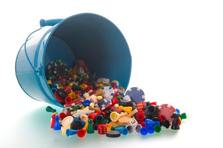Blue bucket full with game parts isolated over white backgroundの写真素材
