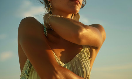 Close up of a beautiful young woman on the beach at sunset.の素材