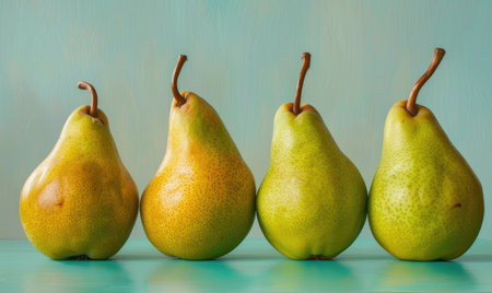 Green and yellow pears on a light blue surfaceの素材