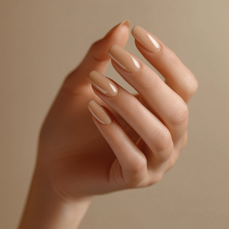 Well-manicured hands with warm beige nail polishの素材