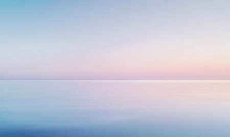 A calm ocean with a pink and orange sky in the backgroundの素材