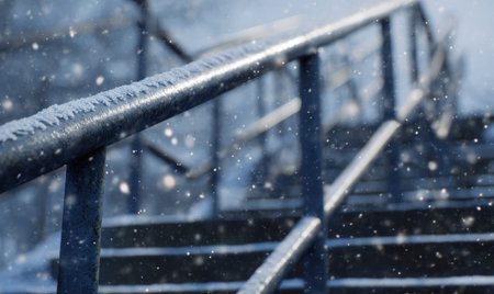 A railing with snow on it. The railing is blue. The snow is whiteの素材