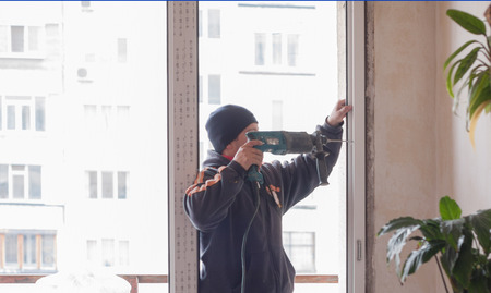 Construction Worker Handyman, drilling and mounting windowの写真素材