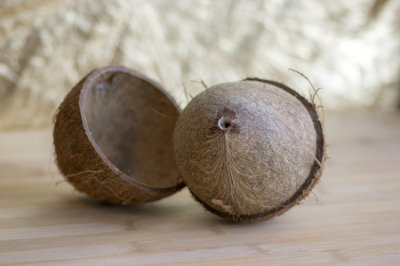 Full coconut with nutshells on wooden bambo tableの写真素材