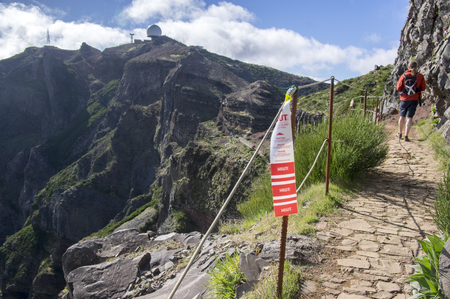 Pico Ariero / MADEIRA island, PORTUGAL - April 21, 2017: One of hundreds of red and white signs on the road of the famous utra-trail cross country race named MIUTのeditorial素材