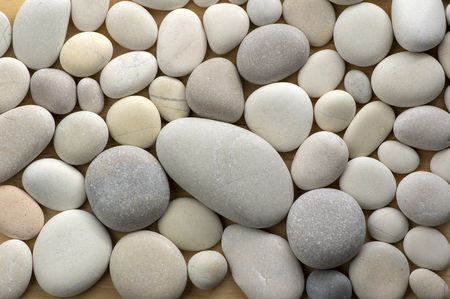 Group of white and grey pebbles, one by ony, simplicity stone 