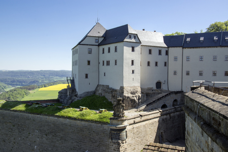 Konigstein Fortress, also called Saxon Bastille in hilltop historical fortress near Dresden in Saxon Switzerland in Germany, surrounded by nature and Elbe river, blue skyの写真素材