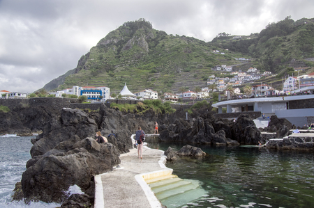Porto Moniz, Madeira / PORTUGAL - April 20, 2017: Lava pools complex with people on the end of Madeira winter season, pool water had refreshing 18 degrees Celsiusのeditorial素材