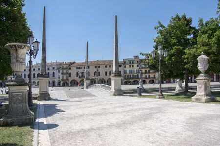 Padua / ITALY - June 12, 2017: Beautiful summer day on Prato della Valle square with water canal. Amazing white italian sculptures. Greenery, blue sky and sunlight.のeditorial素材