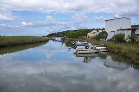 Secovlje Saltworks, Piran / SLOVENIA - September 9, 2019: View of water channel with boats, way of...