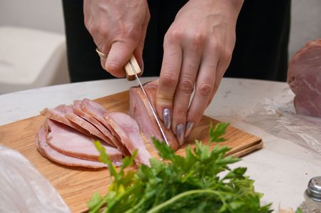 Woman slicing meatの写真素材