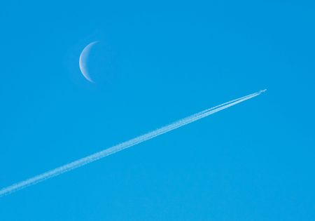 Jet airplane and moon.の写真素材