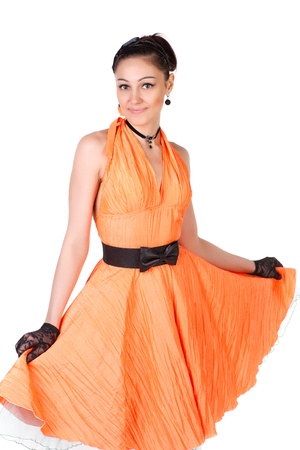 Young dancer woman in orange retro dress の写真素材