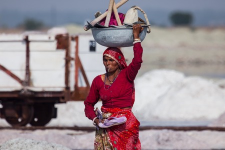 Indian woman with instruments on salt mineのeditorial素材