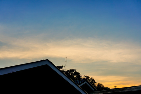 view of black shadow the roof house with background at sunsetの写真素材