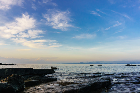 view of rocks at dusk illuminated by a warm light on the sea, Krabi Province, thailand , Dark toneの写真素材