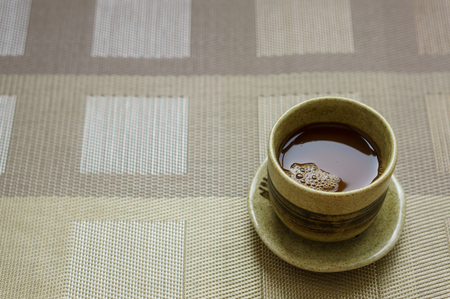 Coffee in a brown cup Put on the padの写真素材